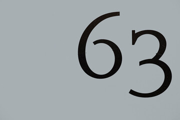 house number 63 painted at the  wall