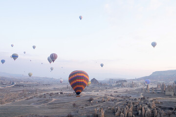 Hot Air Balloons are flying at sunrise in Cappadocia valley, Turkey