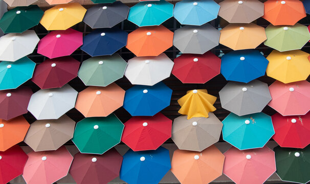 Lots of colorful umbrellas in the wall, diffrent concept idea, powerlessness concept