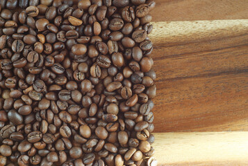 Coffee beans lie on a wooden board. fragrant morning