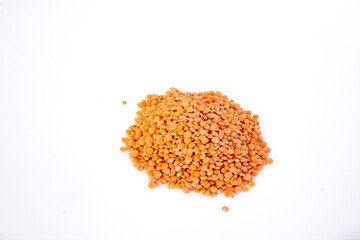 Red lentils on white background, source of protein and minerals such as iron. Vegan and vegetarian food. Copy space.