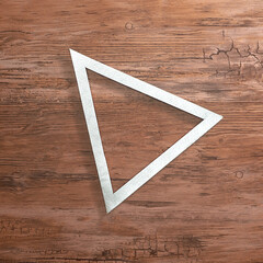 Silver triangular frame on a wooden background. Text space. Top view. Minimal style.