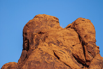 Overton, Nevada, USA - December 11, 2010: Valley of Fire. Closeup up of red-brown veiled head held together under blue sky.