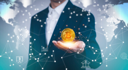 Businessman Hand holding Bitcoin New virtual money coin over us dollars close up, Digital Money and Bitcoin Concept. Cryptocurrency golden coin, stock exchange graph background. Digital money concept.