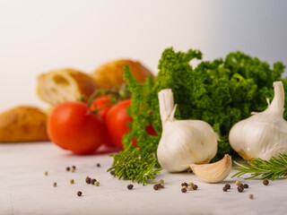 Useful products, vitamins on a white background - garlic, tomatoes, herbs, baguette. Cooking, salad ingredients. Healthy lifestyle, diet food, organic food. Advertising business, banner.