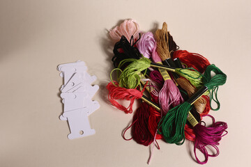 handiwork concept - a pile of embroidery floss and bobbins flat lay