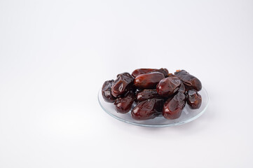 Dry pitted dates fruits on white background. Ramadan fasting concept. Traditional Muslim food during Holy month of Ramadan Kareem.