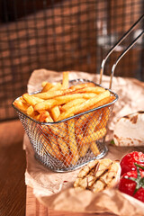 French fries in metal basket. Fast food set.