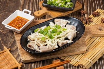 powder sausage in a dish chilli sauce isolated on wooden board side view on table taiwan food