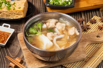 squid soup slabs in a bowl isolated on wooden board side view on table taiwan food