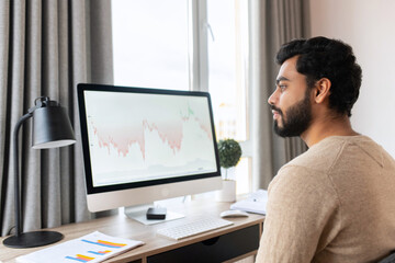 Businessman professional is working on project, writing email to client. Serious concentrated determined young bearded office worker in business casual clothes, sitting at the desk, typing on laptop