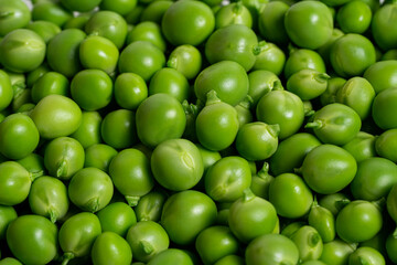 Green peas. Green background. Green peas top view. Fresh organic green peas. Vegetable harvest. Healthy vegetarian food
