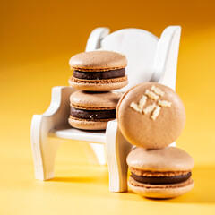 Homemade Chocolate macaron cookies with cocoa dusted on top and ganache filling