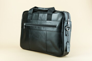 men's leather bag on a light brown background 