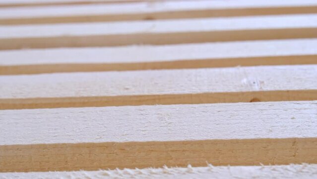 Sawn boards lie on the floor parallel to each other for drying. Preparation for the installation of an eco-friendly wooden floor in a rural house. Lumber from the sawmill