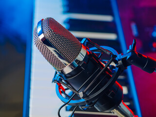 Close-up. Modern microphone and midi keyboard, modern synthesizer. Recording studio, vocals, music,...
