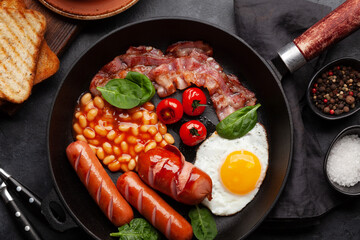 English breakfast with fried eggs, beans, bacon and sausages