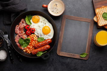 English breakfast with fried eggs, beans, bacon and sausages