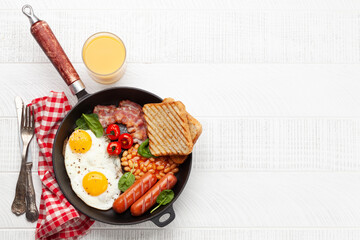 English breakfast with fried eggs, beans, bacon and sausages