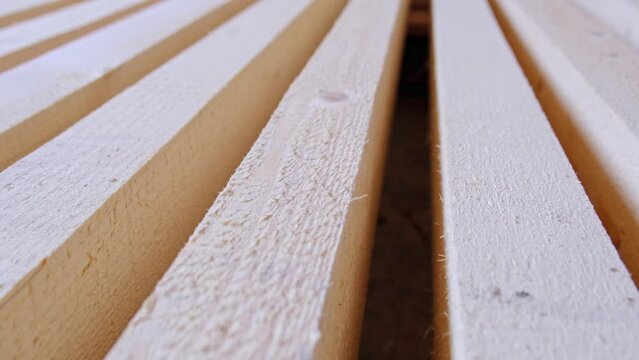 Sawn boards lie on the floor parallel to each other for drying. Preparation for the installation of an eco-friendly wooden floor in a rural house. Lumber from the sawmill