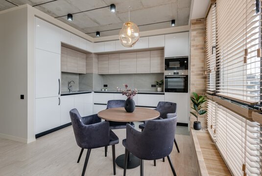 kitchen and dining table near the window in a modern interior in loft style High quality photo