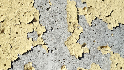 Old yellow paint departing from the wall.