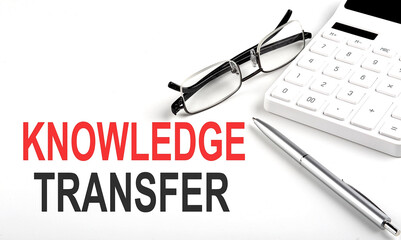 KNOWLEDGE TRANSFER Concept. Calculator,pen and glasses on white background