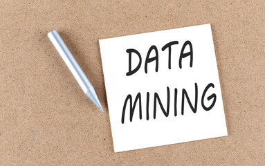 DATA MINING text on sticky note on a cork board with pencil ,