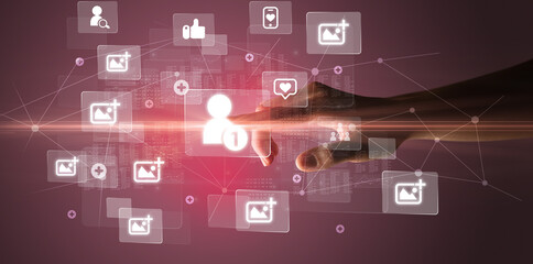 Hand pressing social media multimedia application screen with media icons on futuristic concept