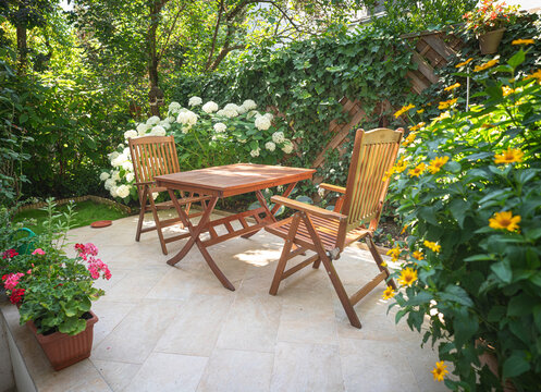 Table and chairs in the garden with nice flowers