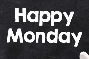 Happy Monday text written on black chalk board.