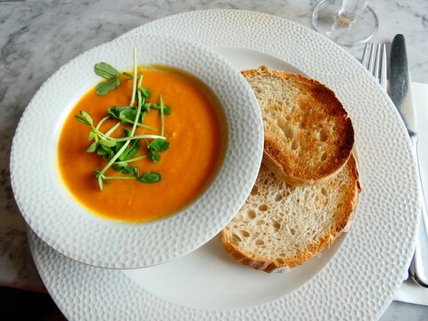 Crab bisque served with bread isolated