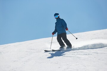 Fototapeta na wymiar Skiing in the winter snowy slopes