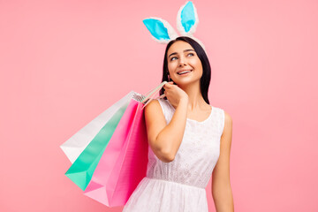Beautiful woman in rabbit ears with shopping bags in her hands, spring shopping, a traditional holiday