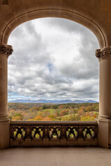 Photo of a beautiful distant mountain vista in the fall through an archway 