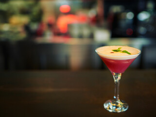 Time to take the edge off. Closeup of a freshly made cocktail standing on its own on a bar counter inside of a restaurant during the day.