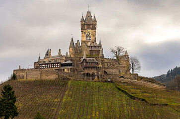 Obraz premium Cochem, Germany, a beautiful historic city on the Moselle river, a view of the Reichsburg castle, located on a hill