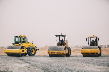 Dozer, excavator, and road rollers working on the mud site