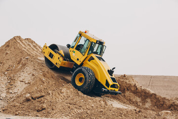 Dozer, excavator, and road rollers working on the mud site