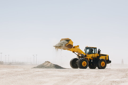 Dozer, excavator, and road rollers working on the mud site