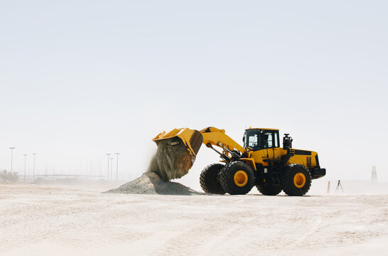 Dozer, excavator, and road rollers working on the mud site