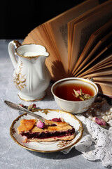 Homemade cake and cup of tea on a table. Close up photo of sweet breakfast.  Still life with retro styled tableware.