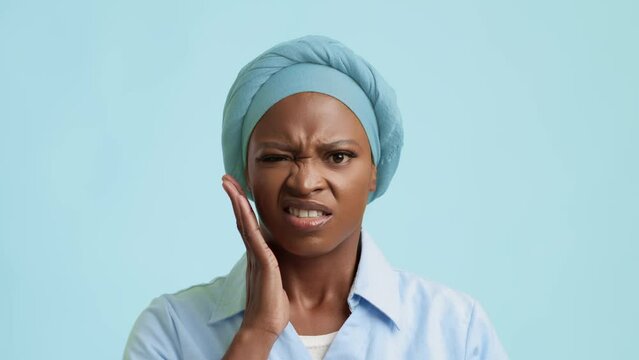 Unhappy African American Female Suffering From Toothache On Blue Background