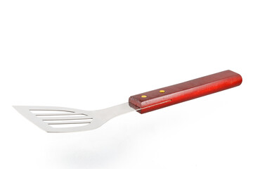 BBQ spatula isolated on white background. Stainless steel grill spatula with wooden handle. Close-up.