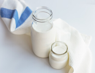 Glass bottles with milk on the table.