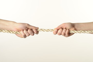 
male and female hands pull the rope on a white background close-up