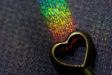 Vintage key. .Antique key. Retro key with a heart shape on  on colorful fabric