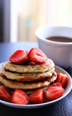 closeup pancakes with strawberries and cup of coffee food sweet breakfast dessert beverage