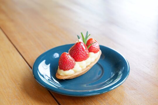 Strawberry tart on the deep blue dish.