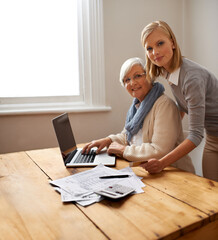 Lending a hand with Grandmas tax returns. A granddaughter helping her grandmother with her budget.